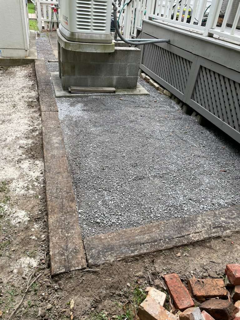 New gravel pad with timber edging beside a home