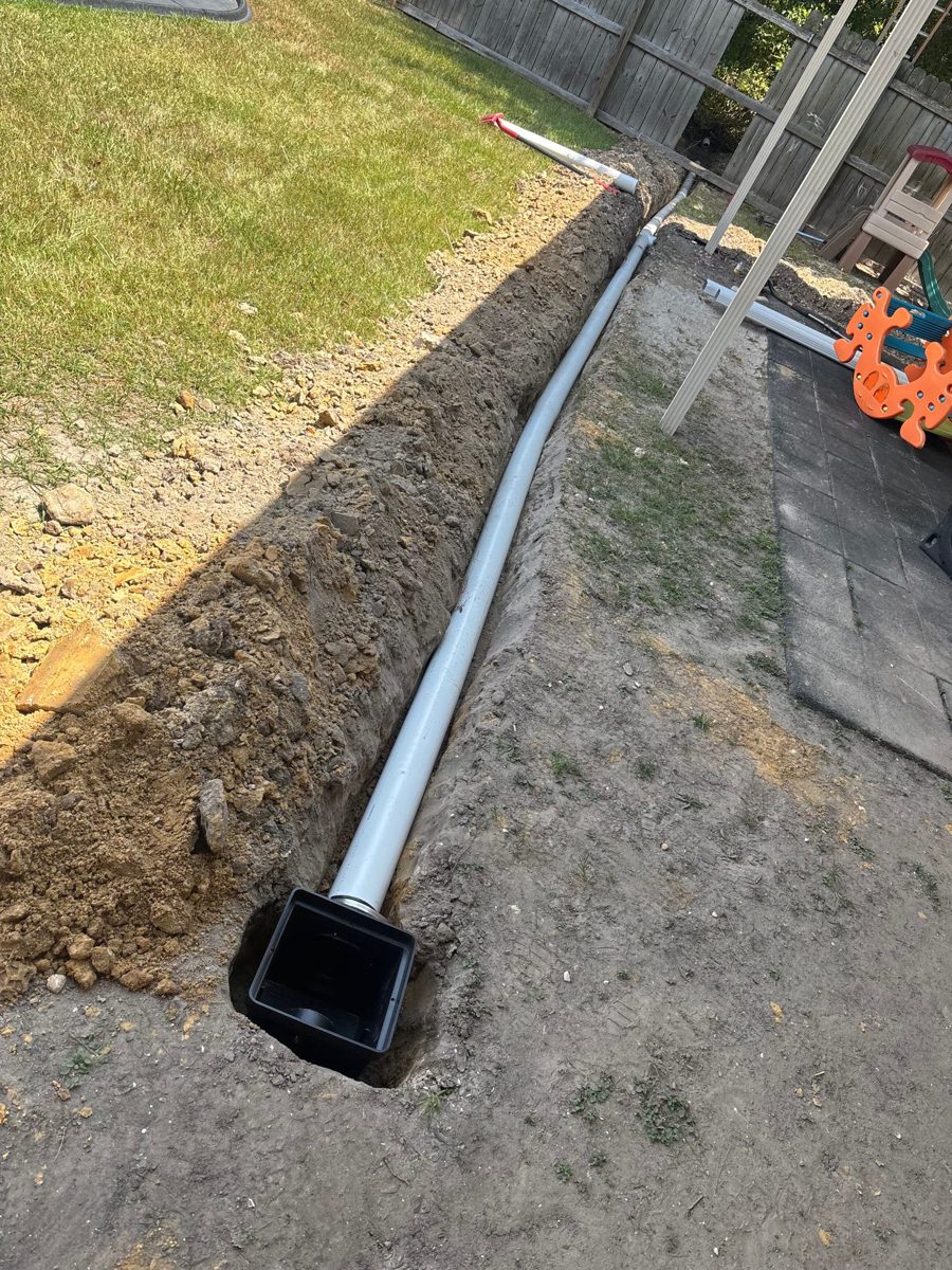 French drain pipe and catch basin set in the trench